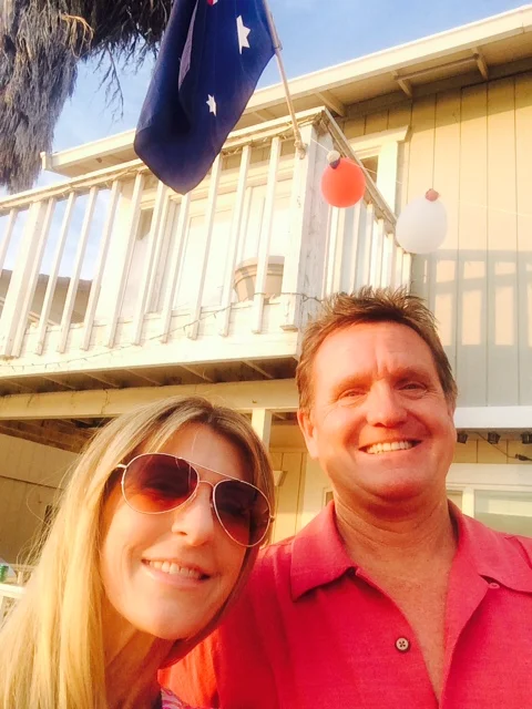 Tom and his wife in front of a hotel